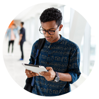 Male factory worker reviews issues on tablet device