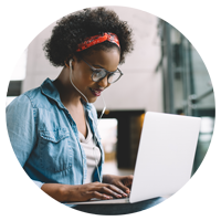 Student working from laptop with headphones in
