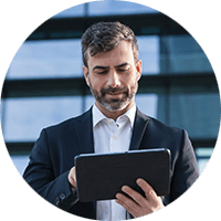 Businessman outside on tablet