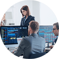 Business professionals viewing graphs on desktop computers