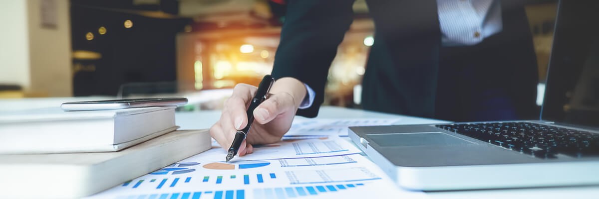 Business professional sitting on floor in modern living room and working on laptop computer. Remote mobile work