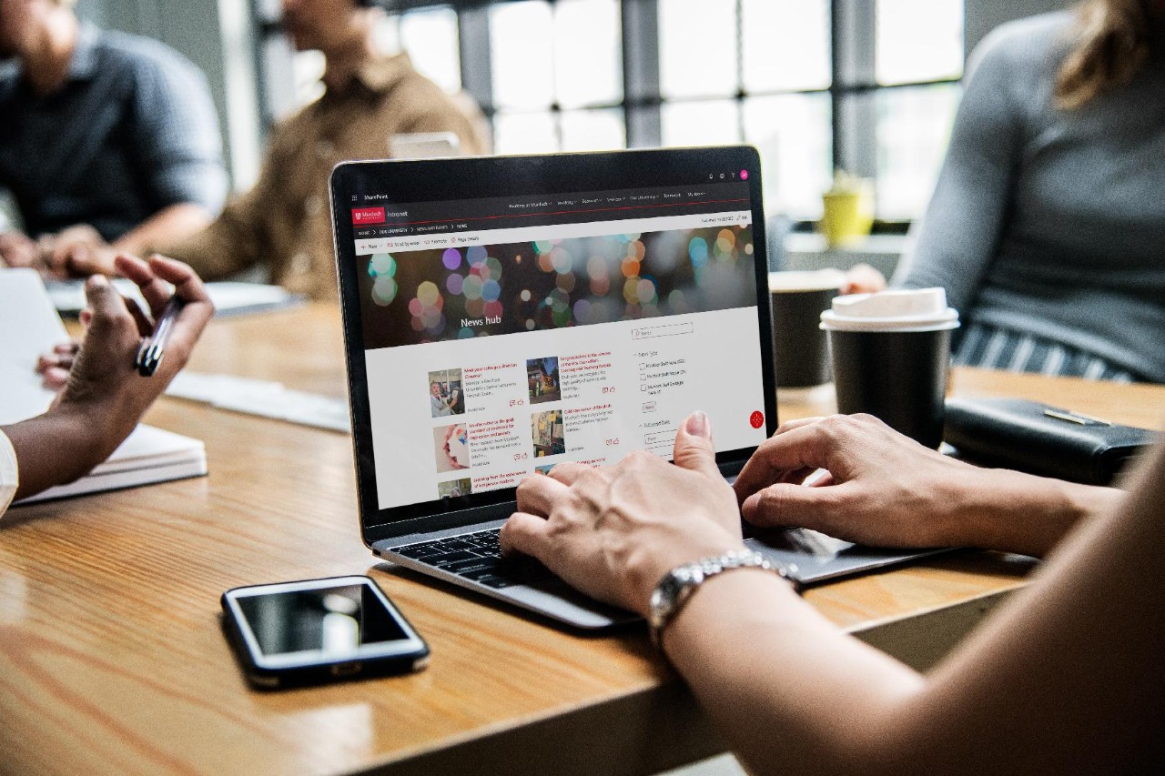 Woman checking her email in a meeting Woman checking her email in a meeting