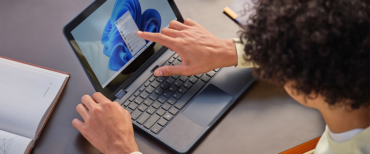 Empower hybrid learning with technologies that enable schools and universities to quickly ramp up distance learning. Student touching Microsoft Surface device