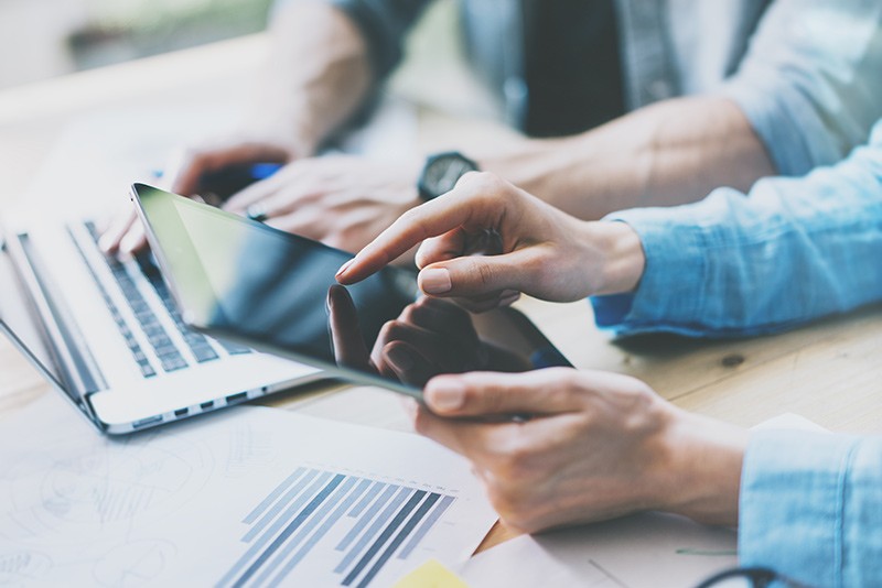 Business professionals using tablet and notebook computers to conduct business