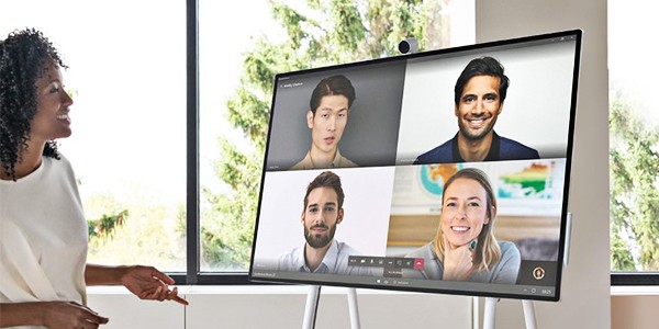 Group of older students working on Microsoft devices