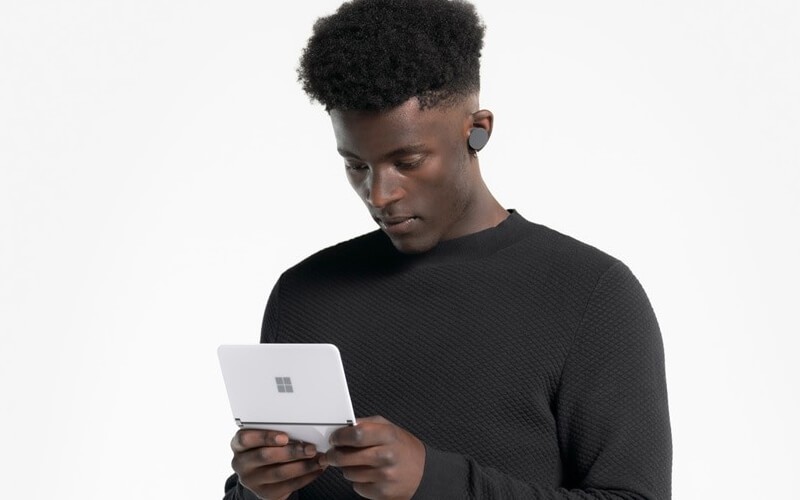 Male half body using Surface Duo