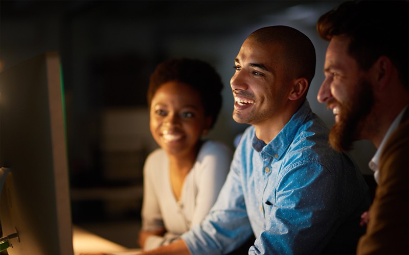 Coworkers smiling together at desk