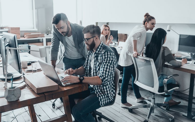 Open modern office with team members collaborating