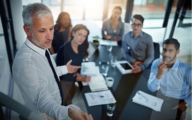 Team discussing IT strategy road map in modern conference room