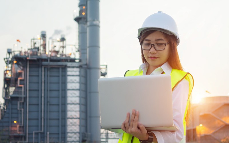 a real-world representative structure on a cloud data platform Business professional using laptop on site