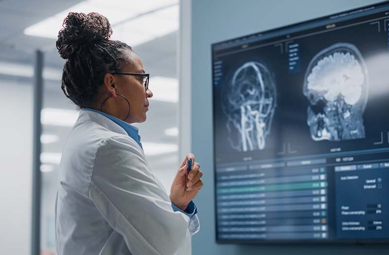 Neurologist reviewing patient data on touchscreen display