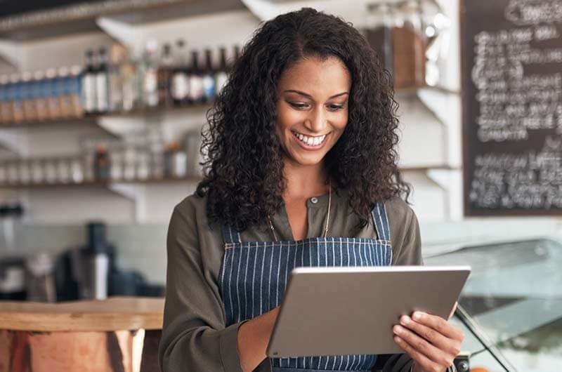 Small business owner on tablet using modern app