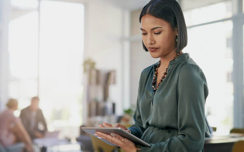 Businesswoman on tablet in modern office