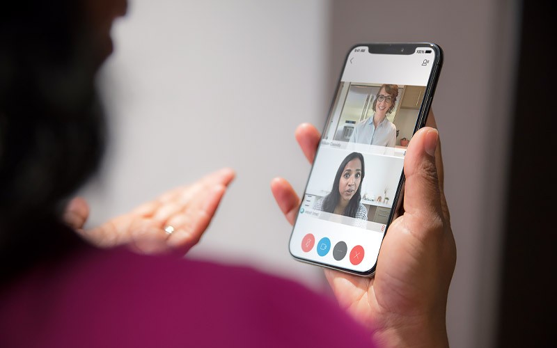 Keep your teams connected, whenever and wherever they work Woman on video conference call using Cisco Webex on a mobile device