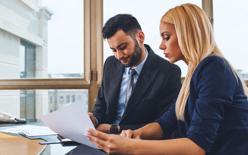 Applications to support your employees Two business professionals meet over laptop computer
